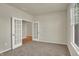Neutral bedroom with plush carpeting, double French doors, bright natural light, and ample space at 7158 Rose Hill Ave, Brownsburg, IN 46112