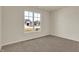 Cozy bedroom with neutral walls, soft carpet, and a bright window overlooking the outdoors at 7158 Rose Hill Ave, Brownsburg, IN 46112