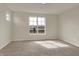 Bedroom with neutral carpet and a large window showcasing an outdoor view at 7158 Rose Hill Ave, Brownsburg, IN 46112