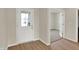 Inviting entryway with wood floors and a glass-paneled door leading to a carpeted room at 7158 Rose Hill Ave, Brownsburg, IN 46112