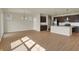 Sunlit open-concept living space with modern kitchen and dining area, perfect for entertaining at 7158 Rose Hill Ave, Brownsburg, IN 46112
