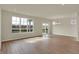Bright living room featuring hardwood floors, large windows, and sliding glass door leading to outdoor space at 7158 Rose Hill Ave, Brownsburg, IN 46112