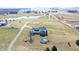 Wide aerial shot capturing the property's farmhouse, pool, pond, driveway, and surrounding acreage at 7418 W Old Sr 252, Edinburgh, IN 46124