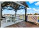 Relax on this back deck featuring a gazebo with string lights, a grill, and seating at 7418 W Old Sr 252, Edinburgh, IN 46124