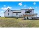 Expansive backyard featuring a deck with a gazebo, walkout basement, and lush green lawn at 7418 W Old Sr 252, Edinburgh, IN 46124