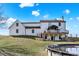 Backyard featuring a white home, a wooden deck, an above-ground pool, and a blue sky at 7418 W Old Sr 252, Edinburgh, IN 46124