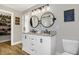 Bathroom boasting a double vanity, stylish mirrors, and an open doorway to a walk-in closet, blending design and function at 7418 W Old Sr 252, Edinburgh, IN 46124