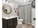 Comfortable bathroom with stylish shower curtain, wood-like floors, and decorative mirror at 7418 W Old Sr 252, Edinburgh, IN 46124
