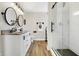 Modern bathroom featuring a double vanity, sleek fixtures, and a glass-enclosed shower with white subway tiles at 7418 W Old Sr 252, Edinburgh, IN 46124