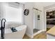Bright bathroom showcasing a freestanding tub, a glass-enclosed shower, and stylish fixtures with natural light at 7418 W Old Sr 252, Edinburgh, IN 46124