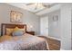 Inviting bedroom with wood flooring, a patterned bedspread, stylish pillows, and updated lighting at 7418 W Old Sr 252, Edinburgh, IN 46124