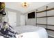 Teenage bedroom with mounted TV, wooden shelves, and a large window at 7418 W Old Sr 252, Edinburgh, IN 46124