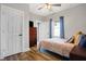 Cozy bedroom featuring hardwood floors, a ceiling fan and neutral walls at 7418 W Old Sr 252, Edinburgh, IN 46124