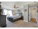 Spacious bedroom with stylish gray furniture, ceiling fan, natural light from the window, and a relaxing atmosphere at 7418 W Old Sr 252, Edinburgh, IN 46124