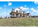 Beautiful farmhouse with a wrap-around porch featuring comfortable seating areas and scenic views at 7418 W Old Sr 252, Edinburgh, IN 46124