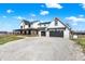 Charming farmhouse with a covered porch, rocking chairs, and a two-car garage at 7418 W Old Sr 252, Edinburgh, IN 46124