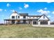 Charming two-story farmhouse with a covered porch, rocking chairs, and a two-car garage at 7418 W Old Sr 252, Edinburgh, IN 46124