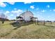 Beautiful white home featuring a wooden deck, a covered porch, manicured lawn, and a fenced perimeter at 7418 W Old Sr 252, Edinburgh, IN 46124