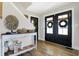 Welcoming foyer with a decorative console table, stylish decor, and elegant double doors at 7418 W Old Sr 252, Edinburgh, IN 46124