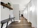 Bright hallway with hardwood floors, bench with shelf, natural light, and sheer curtains, creating a welcoming space at 7418 W Old Sr 252, Edinburgh, IN 46124