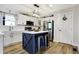 Charming kitchen with a navy blue island, white cabinets, and modern appliances at 7418 W Old Sr 252, Edinburgh, IN 46124