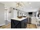 Open concept kitchen with a large island, stainless steel appliances, and a white barn door at 7418 W Old Sr 252, Edinburgh, IN 46124