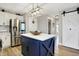 Bright kitchen with large island, stainless refrigerator, quartz countertops, and light fixture at 7418 W Old Sr 252, Edinburgh, IN 46124