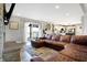 Cozy living room featuring a leather sectional sofa and sliding doors leading to an outdoor deck area at 7418 W Old Sr 252, Edinburgh, IN 46124
