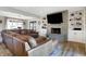 Spacious living room with a large leather sectional sofa and stone fireplace, creating a cozy atmosphere at 7418 W Old Sr 252, Edinburgh, IN 46124