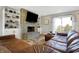 Comfortable living room with a stone fireplace, built-in shelving, and a plush sectional sofa at 7418 W Old Sr 252, Edinburgh, IN 46124