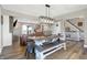 Open living space featuring a dining table with bench seating, seamlessly flowing into the living area at 7418 W Old Sr 252, Edinburgh, IN 46124