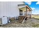 Exterior view showcasing the covered porch with wooden stairs leading to the yard at 7418 W Old Sr 252, Edinburgh, IN 46124