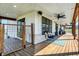 Inviting covered porch with comfortable seating, ceiling fans, and stylish decor at 7418 W Old Sr 252, Edinburgh, IN 46124