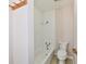 Bathroom features tub and shower combination with tile surround and low flow toilet at 7953 Forest Park Dr, Indianapolis, IN 46217