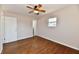 Cozy bedroom with a ceiling fan, natural light, and well-maintained hardwood floors at 7953 Forest Park Dr, Indianapolis, IN 46217