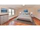 Bright bedroom featuring hardwood floors, a large window, and stylish decor at 7953 Forest Park Dr, Indianapolis, IN 46217