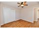 Bedroom featuring wood flooring, neutral walls, and a closet with sliding doors at 7953 Forest Park Dr, Indianapolis, IN 46217