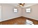 Bedroom featuring hardwood floors, a ceiling fan and two windows at 7953 Forest Park Dr, Indianapolis, IN 46217