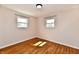 Bright bedroom with hardwood floors and plenty of natural light from two windows at 7953 Forest Park Dr, Indianapolis, IN 46217