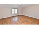 Bedroom featuring hardwood floors, a large window, and baseboard heat at 7953 Forest Park Dr, Indianapolis, IN 46217