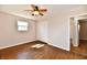 Comfortable bedroom with hardwood floors, a ceiling fan, and a convenient closet space at 7953 Forest Park Dr, Indianapolis, IN 46217