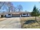 Charming ranch-style home with a well-manicured front yard and a long driveway at 7953 Forest Park Dr, Indianapolis, IN 46217