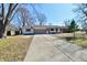 Charming ranch-style home with a well-manicured front yard and a long driveway at 7953 Forest Park Dr, Indianapolis, IN 46217