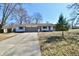 Charming ranch-style home with a well-manicured front yard and a long driveway at 7953 Forest Park Dr, Indianapolis, IN 46217