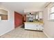 Eat-in kitchen with white cabinets, stainless steel appliances, and decorative brick wall at 7953 Forest Park Dr, Indianapolis, IN 46217