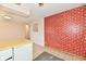 Kitchen featuring brick accent wall, yellow counters, dishwasher, tile flooring, and neutral walls at 7953 Forest Park Dr, Indianapolis, IN 46217
