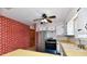 Functional kitchen with stainless steel appliances, white cabinets, and a unique brick wall feature at 7953 Forest Park Dr, Indianapolis, IN 46217