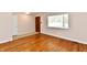 View of an open living room with wood flooring, a large window, and a front entry at 7953 Forest Park Dr, Indianapolis, IN 46217