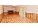 Spacious living room featuring a cozy red brick fireplace and wood-look flooring at 7953 Forest Park Dr, Indianapolis, IN 46217