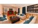 Spacious living room featuring hardwood floors, comfortable seating, and a fireplace at 7953 Forest Park Dr, Indianapolis, IN 46217
